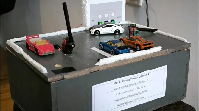SMART Parking System model with toy cars in the bays and the ultrasonic barrier post